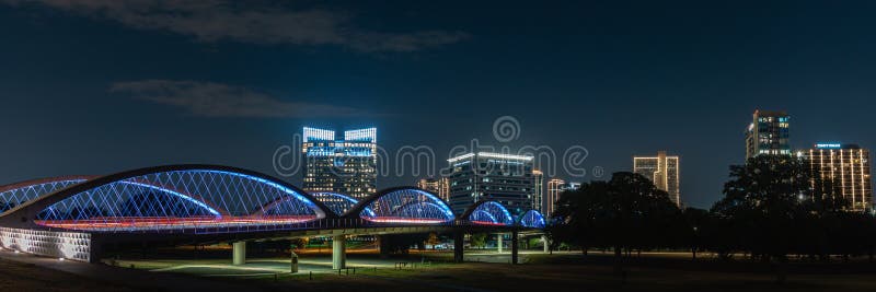 A view of the 7th Street Bridge in Fort Worth Texas with the city in the backdrop. This is a panorama view of downtown at night. A view of the 7th Street Bridge in Fort Worth Texas with the city in the backdrop. This is a panorama view of downtown at night.