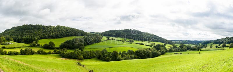 Broad panorama of the countryside in North Wales with green field in foreground. Broad panorama of the countryside in North Wales with green field in foreground