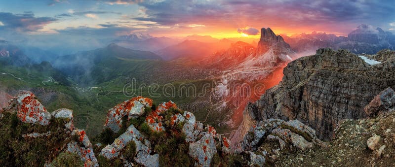 Panorama dramatic sunset in dolomites alp mountain from peak Nuvolau