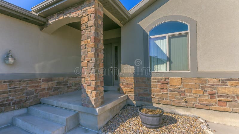 Panorama Facade of a home with a rocky yard and small front porch royalty free stock image Panorama Facade of a home with a rocky yard and small front porch royalty free stock image