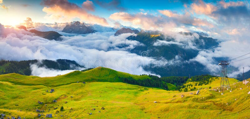 Panorama of the foggy Val di Fassa valley with passo Sella