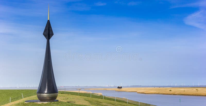 Panorama of a large buoy on top of the dike in the Dollard region, Holland