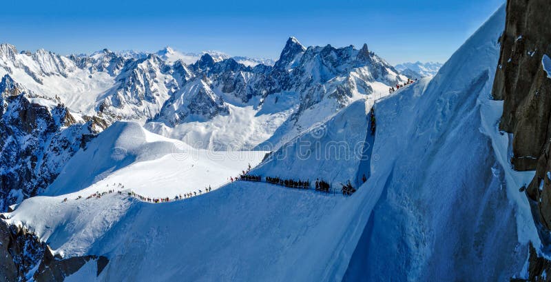 People descending from Aiguille du Midi for ski touring in Vallee Blanche (White Valley), France. Being one of the most famous off-piste descents, this glacial route is very popular in early spring. People descending from Aiguille du Midi for ski touring in Vallee Blanche (White Valley), France. Being one of the most famous off-piste descents, this glacial route is very popular in early spring.