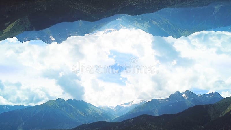 Panorama of mountains with mirror image effect. Shot. Beautiful top view of green valleys of mountains on background