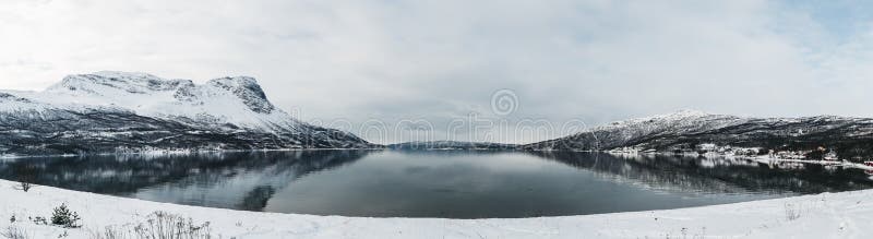 Panorama Norway Rombaksfjorden, fjord view with mountains on both sides on a bright spring day with winter looking landscape with snow. Panorama Norway Rombaksfjorden, fjord view with mountains on both sides on a bright spring day with winter looking landscape with snow