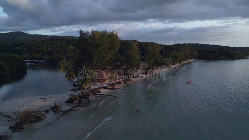 Beach bar in the evening on headland sunset Spectacular aerial view flight drone