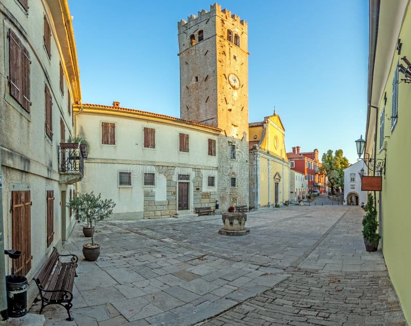 Panorama over the central square of Motovun with St. Stephen&x27;s church and city gate at sunrise