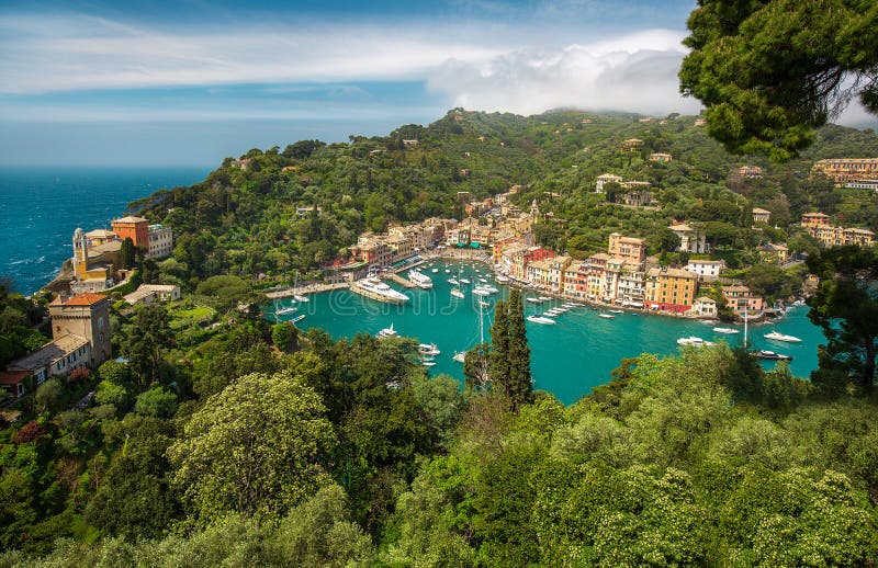 Panorama of Portofino town with multicolored houses and villas, sea and harbor bay with fishing boats and luxury yachts stock photography Panorama of Portofino town with multicolored houses and villas, sea and harbor bay with fishing boats and luxury yachts stock photography