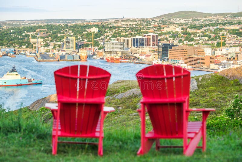 Panorama of St. John`s with two characteristic red chairs, Newfo royalty free stock photo Panorama of St. John`s with two characteristic red chairs, Newfo royalty free stock photo