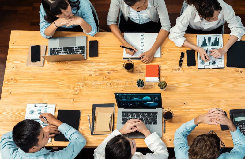 Panorama top view diverse analyst team analyzing financial data. Meticulous stock photo