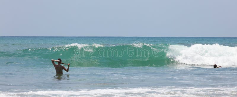 Panoramic view of Manuel Antonio national park beach in Costa Rica, most beautiful beaches in the world, Central America pacific ocean, with beautiful wet girl in bikini. Panoramic view of Manuel Antonio national park beach in Costa Rica, most beautiful beaches in the world, Central America pacific ocean, with beautiful wet girl in bikini.