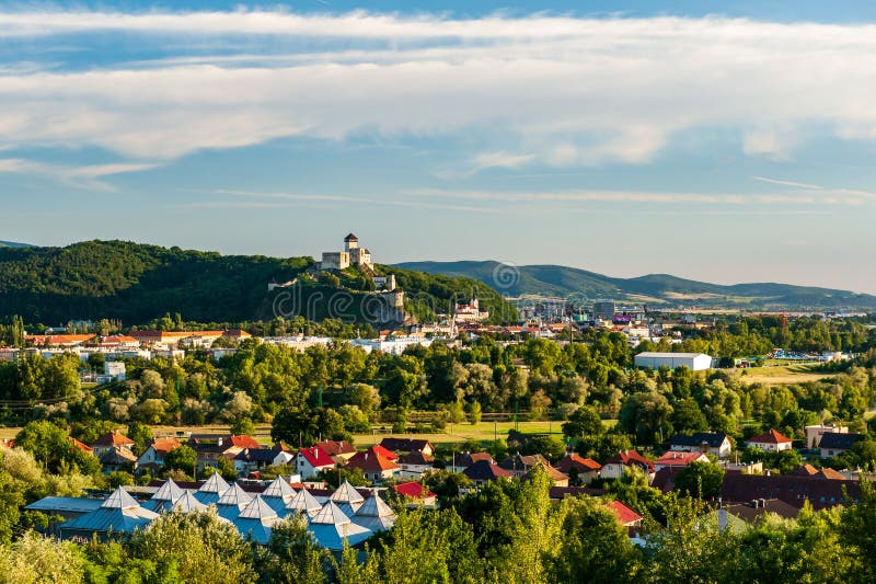 Panorama view of medieval newly restored Trencin castle over the Vah river with view of Trencin city in golden sunny summer day