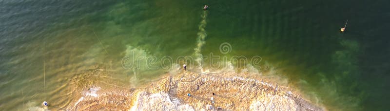 Panoramic aerial view fishermen bank and wade fishing with waterproof jacket at Lavon Lake, Texas, USA