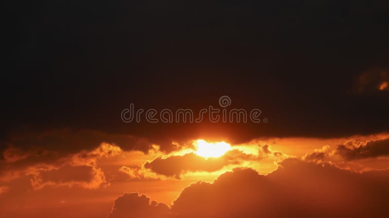 Panoramic aerial view of sunset under storm clouds with dramatic bright sunlight and silhouette clouds. Image use for meteorology royalty free stock photo