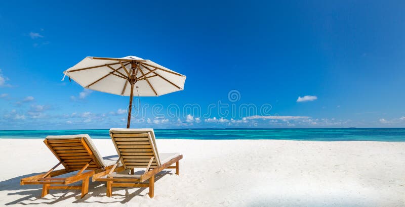 Panoramic beach paradise. Couple chairs beds with umbrella. Romantic couples getaway freedom landscape, shore tropical coast