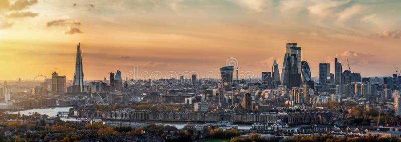 Panoramic, elevated view to the skyline of London during a autumn sunset, United Kingdom. Panoramic, elevated view to the skyline of London during a autumn sunset, United Kingdom