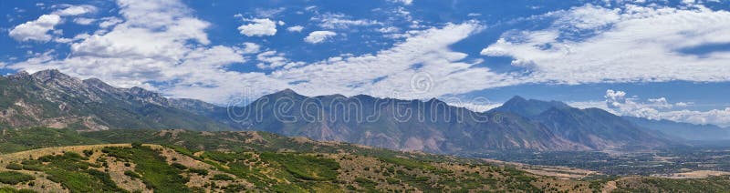 Panoramic Landscape view from Travers Mountain of Provo, Utah County, Utah Lake and Wasatch Front Rocky Mountains, and Cloudscape.
