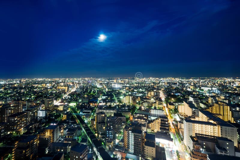 Panoramic modern city skyline bird eye aerial night view under dramatic neon glow and beautiful dark blue sky in Tokyo, Japan