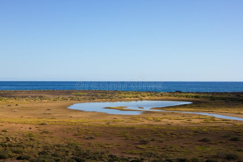 Panoramic ocean view. Volcano, black rocks. Lake. Panoramic ocean background view. Sea lake. Horizon stock photos Panoramic ocean view. Volcano, black rocks. Lake. Panoramic ocean background view. Sea lake. Horizon stock photos