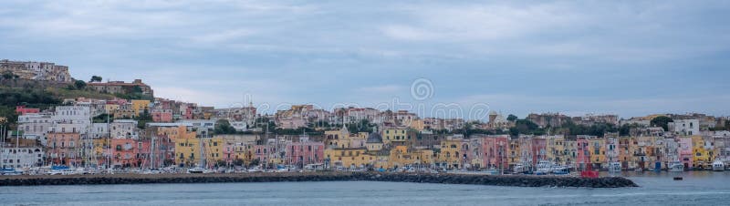 Panoramic photo of the harbour front with pastel coloured houses on the island of Procida Italy, photographed from the water. royalty free stock photography Panoramic photo of the harbour front with pastel coloured houses on the island of Procida Italy, photographed from the water. royalty free stock photography