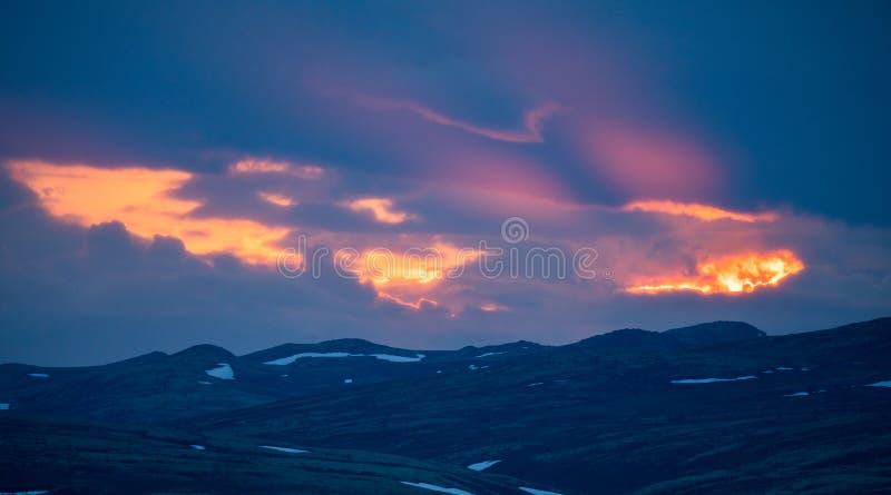 Panoramic shot of mountain scenery during sunset, blue hour and pink dramatic skies and light royalty free stock photo