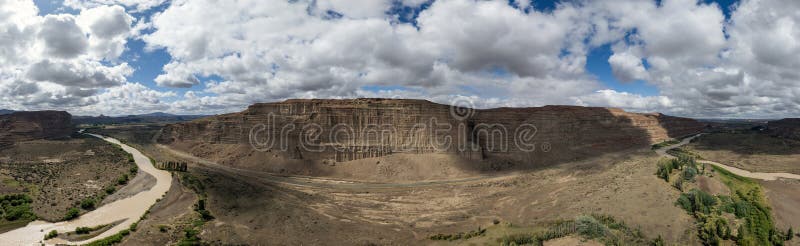 Panoramic shot of sandstone landscap with big cliffs with river flowing royalty free stock image