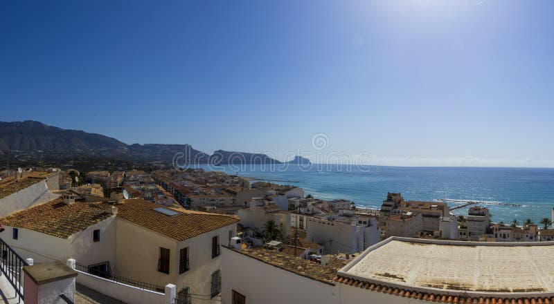 Panoramic view of Altea, Spain, showcasing white rooftops and coastline under a clear blue sky, capturing the beauty of stock photography