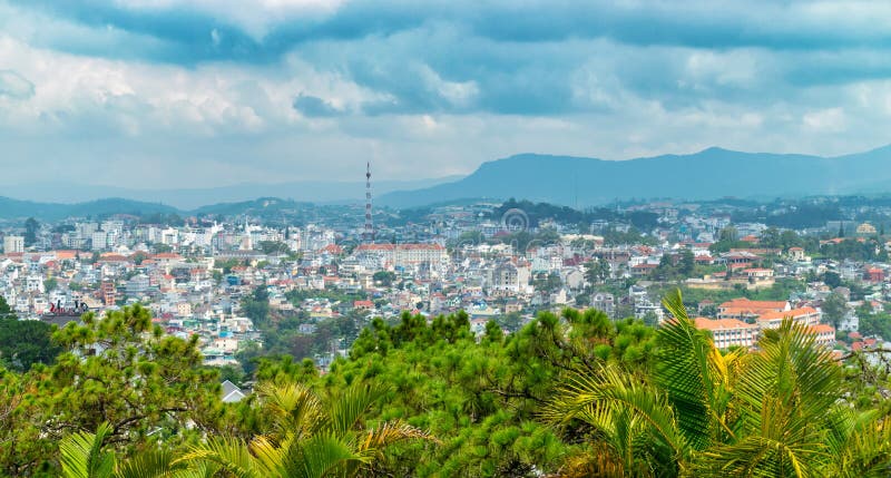 Panoramic view of Dalat with cloudy sky and tropical palms before tropical rain