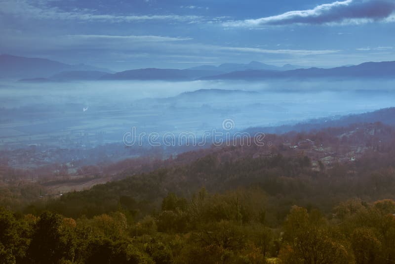 Panoramic view from a hill in the evening with low clouds over the valley royalty free stock photo Panoramic view from a hill in the evening with low clouds over the valley royalty free stock photo