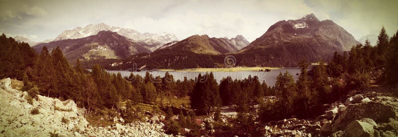 Panoramic view of the landscape around Sils Lake in the upper Engadine Valley Switzerland - Europe - Toned with a retro vintage. Instagram filter effect stock image Panoramic view of the landscape around Sils Lake in the upper Engadine Valley Switzerland - Europe - Toned with a retro vintage. Instagram filter effect stock image