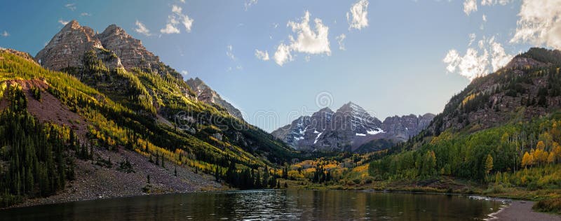 Panoramic view of Maroon Bells peaks and fall colors in the Rocky Mountain National Park