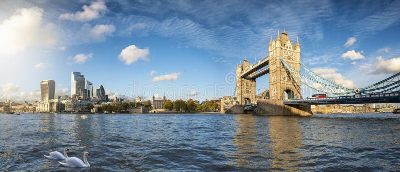 Panoramic view of the modern skyline of London, United Kingdom, from the Tower Bridge to the City on a sunny autumn day with calm Thames river