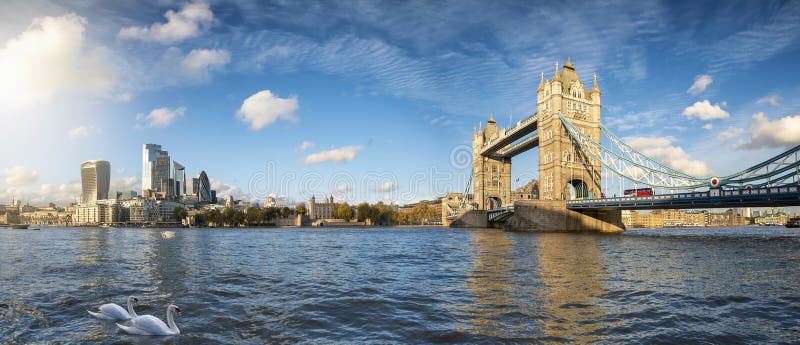 Panoramic view of the modern skyline of London, United Kingdom, from the Tower Bridge to the City on a sunny autumn day with calm Thames river