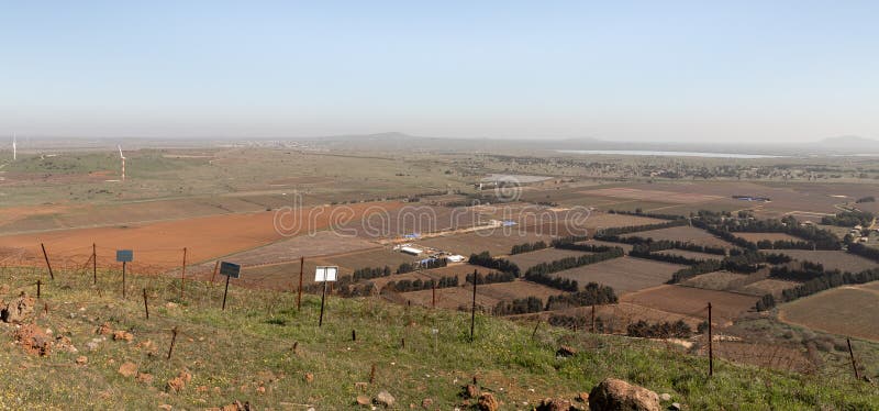 A panoramic view from Mount Bental in the Golan Heights in northern Israel of the nearby valley, settlements, fields, wind turbines and and the abandoned Syrian city of Quneitra in Syria. A panoramic view from Mount Bental in the Golan Heights in northern Israel of the nearby valley, settlements, fields, wind turbines and and the abandoned Syrian city of Quneitra in Syria