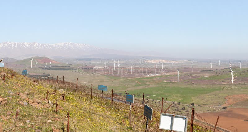 A panoramic view from Mount Benthal of the nearby valley, settlements, fields, wind turbines and the snow-capped peak of Mount Hermon, in the Golan Heights, in northern Israel. A panoramic view from Mount Benthal of the nearby valley, settlements, fields, wind turbines and the snow-capped peak of Mount Hermon, in the Golan Heights, in northern Israel