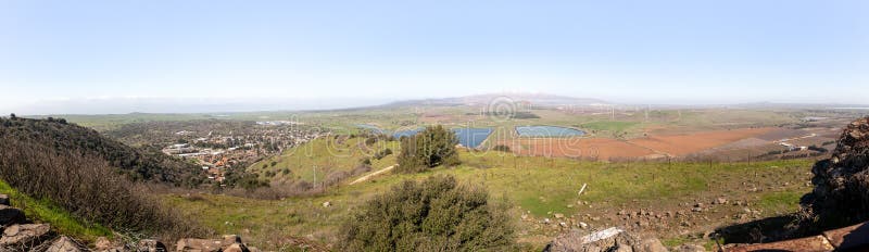 A panoramic view from Mount Benthal of the nearby valley, settlements, fields, wind turbines and the snow-capped peak of Mount Hermon, in the Golan Heights, in northern Israel. A panoramic view from Mount Benthal of the nearby valley, settlements, fields, wind turbines and the snow-capped peak of Mount Hermon, in the Golan Heights, in northern Israel