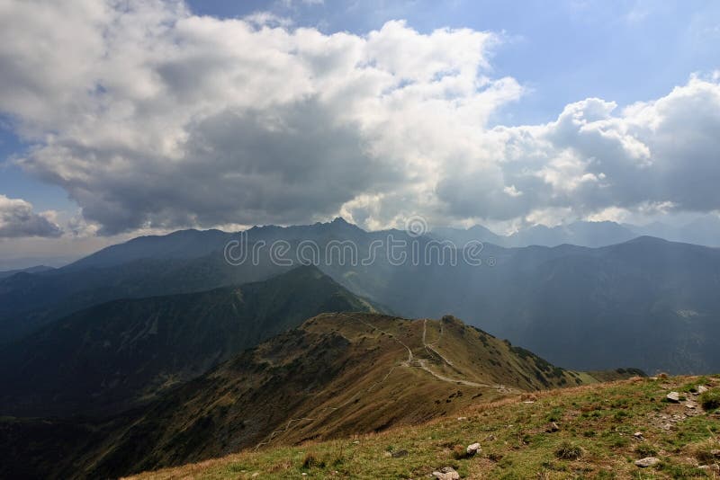 Panoramic view of mountain ridge in back-light, dramatic clouds and pathways web. Autumn in High Tatras mountains. royalty free stock photos Panoramic view of mountain ridge in back-light, dramatic clouds and pathways web. Autumn in High Tatras mountains. royalty free stock photos