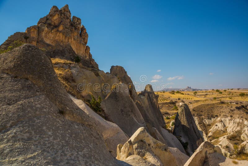 Panoramic view on the mountains and rocks. Cappadocia, Turkey. On the horizon the silhouette of Uchisar. Landscape background. Landscape fortress uchisar stock images, royalty-free photos and pictures