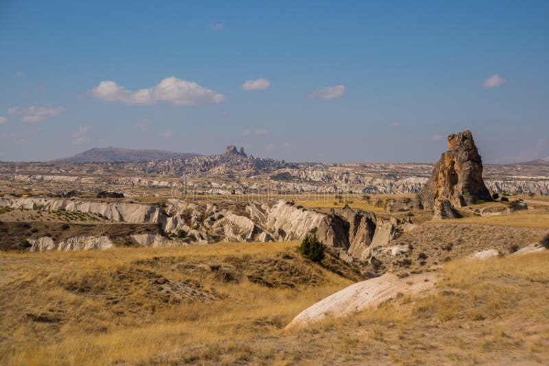 Panoramic view on the mountains and rocks. On the horizon the silhouette of Uchisar. Cappadocia, Turkey. Landscape background. Landscape fortress uchisar stock images, royalty-free photos and pictures