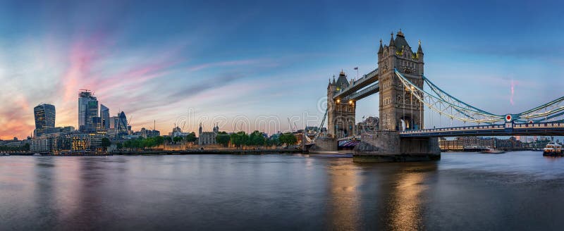 Panoramic view of the skyline of London, UK, during evening: from the Tower Bridge along the Thames river to the skyscrapers of the City