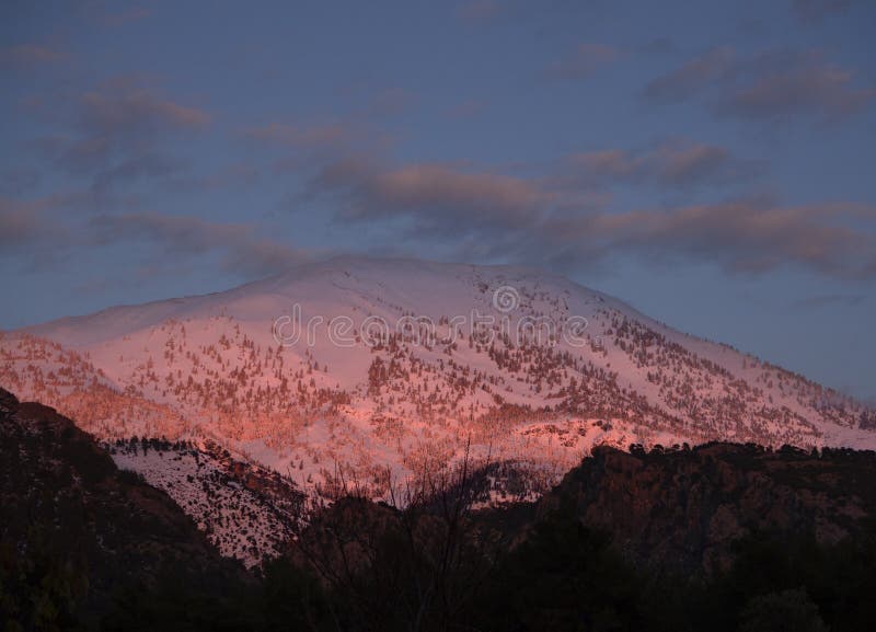 Panoramic view Snow-capped peaks of mount Dirfys spruce forest at sunset on a background of clouds on the island of Evia Euboea