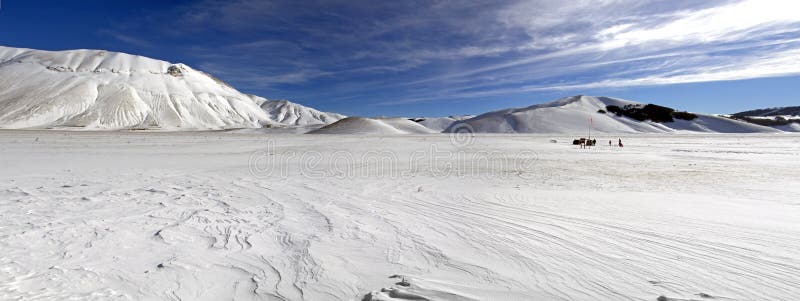 Panoramic view of snowy plateau of Castelluccio of Norcia, in Um