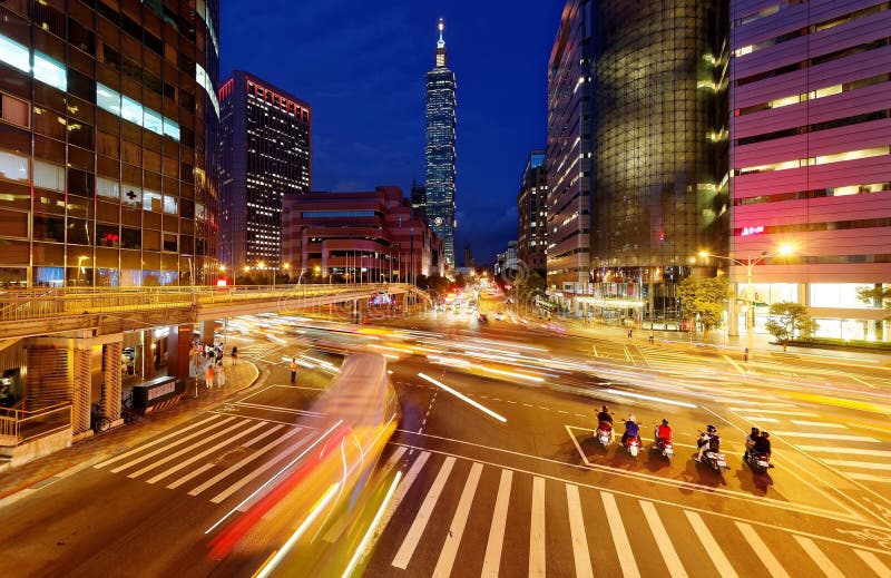 Panoramic view of a street corner in Downtown Taipei City with busy traffic trails at rush hour royalty free stock photography Panoramic view of a street corner in Downtown Taipei City with busy traffic trails at rush hour royalty free stock photography