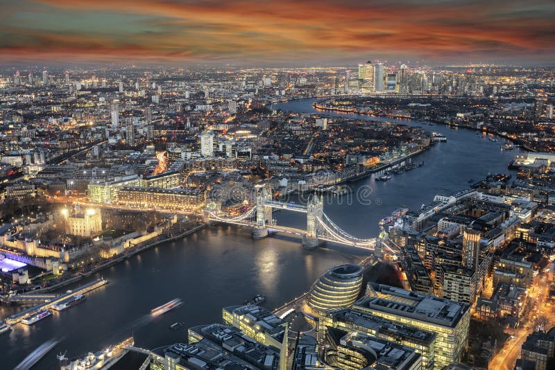 Panoramic view to the skyline of London: from the Tower Bridge along the Thames river to Canary Wharf district during sunset time. Panoramic view to the skyline of London: from the Tower Bridge along the Thames river to Canary Wharf district during sunset time