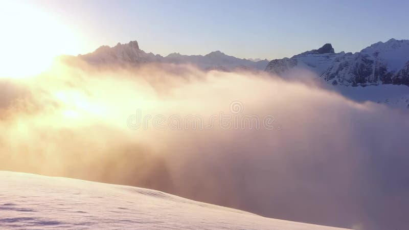 Panoramic view to summit and snow peaks with beautiful sunlight. Scenery view down on snow covered valley. stock illustration
