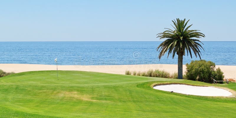 Panoramic views of the golf course to the sea and palm trees. Portugal, Algarve.