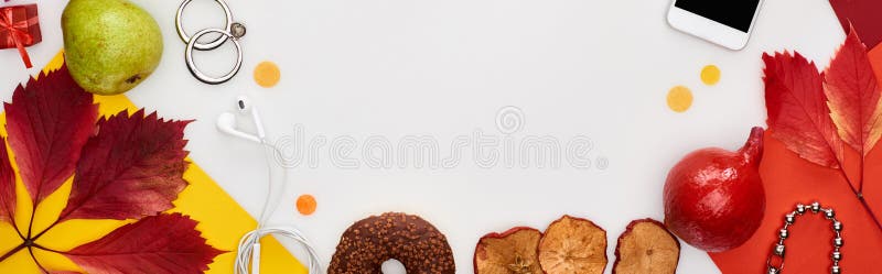 Panoramic shot of fruits, dry leaves, earphones, earrings, donut, smartphone, yellow and red paper isolated on white,stock image. Panoramic shot of fruits, dry leaves, earphones, earrings, donut, smartphone, yellow and red paper isolated on white,stock image