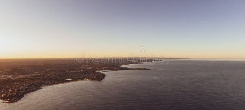Panoramic aerial drone evening view of Northern Beaches, an area in the northern coastal suburbs of Sydney, New South Wales, Australia. Left to right: Curl Curl, Dee Why, Long Reef & Collaroy beaches. Panoramic aerial drone evening view of Northern Beaches, an area in the northern coastal suburbs of Sydney, New South Wales, Australia. Left to right: Curl Curl, Dee Why, Long Reef & Collaroy beaches.