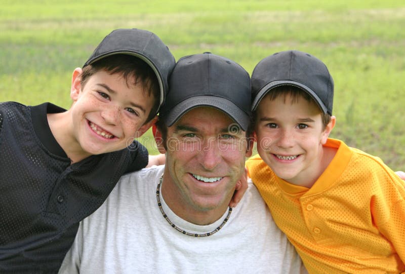 Dad and Boys in their baseball uniforms. Dad and Boys in their baseball uniforms