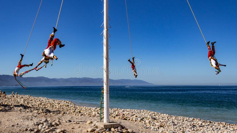 Papantla flyers with a wonderful blue sky, an ancient Mexican tradition, mexican pre-columbian aerial dance, wonderful sunny day on the beach of Puerto Vallarta Jalisco Mexico